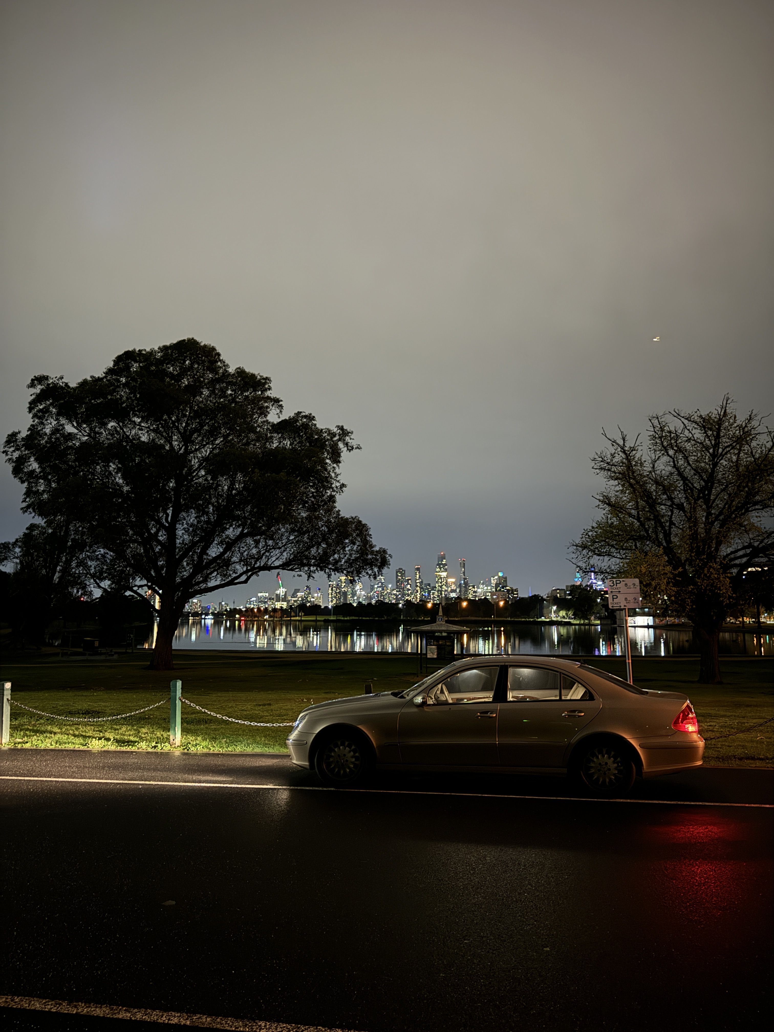 Claire parked at Albert Park, Melbourne city skyline in the background